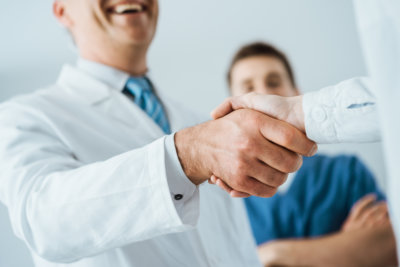 a doctor shaking hands with his patient